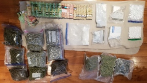 Police display drugs and Canadian currency allegedly seized during a raid on Friday. (OPP/Twitter)