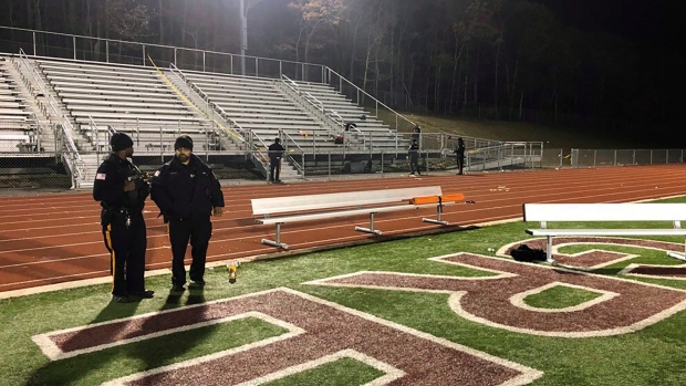 Gunman wounds man, young boy at high school football game