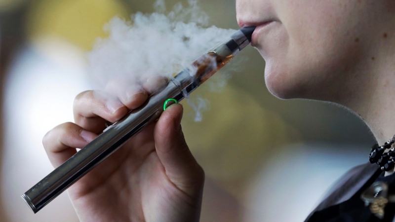 In this Oct. 4, 2019 file photo, a woman is seen using an electronic cigarette. (AP / Tony Dejak, File)