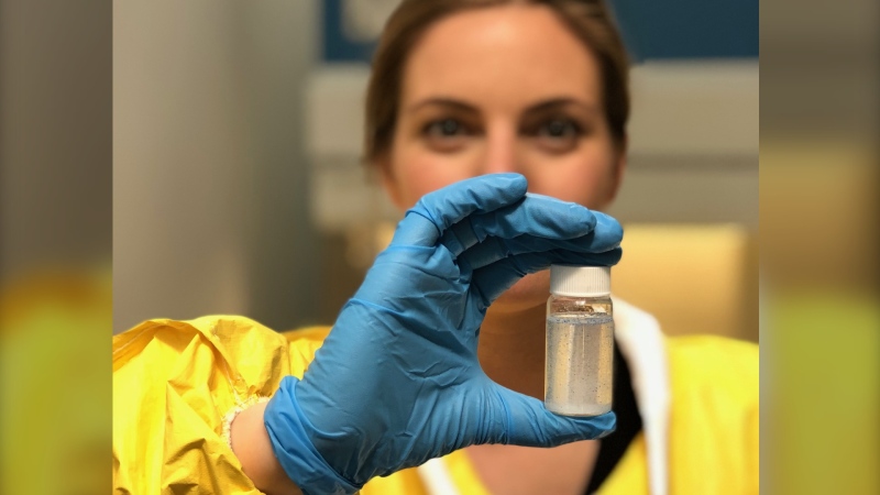 A pioneering study of seven beluga whales in Canada's remote Arctic waters has found microplastics in the innards of every single one. Ocean Wise researcher and Simon Fraser University masters student Rhiannon Moore shows a vial of microplastics at the Ocean Wise Plastics Lab in Vancouver in a November 2019 handout photo. (THE CANADIAN PRESS/HO-Ocean Wise, Valeria Vergara, *MANDATORY CREDIT*)