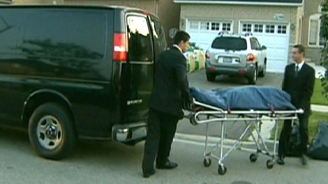Coroners remove the body from the residence in Mississauga, Wednesday, Sept. 9, 2009.