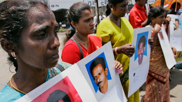 Sri Lankan ethnic Tamil women hold portraits of their family members who had gone missing recently during a protest in Colombo, Sri Lanka, Wednesday, Sept. 9, 2009.  (AP / Eranga Jayawardena)