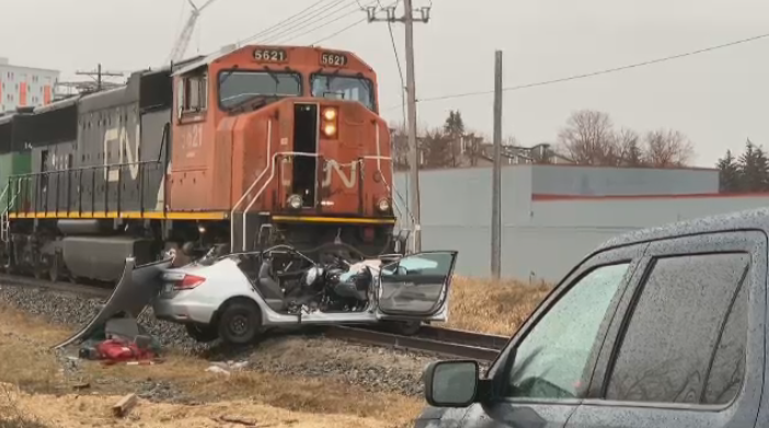 Two people have been taken to hospital after police say a train hit a vehicle in Winnipeg.