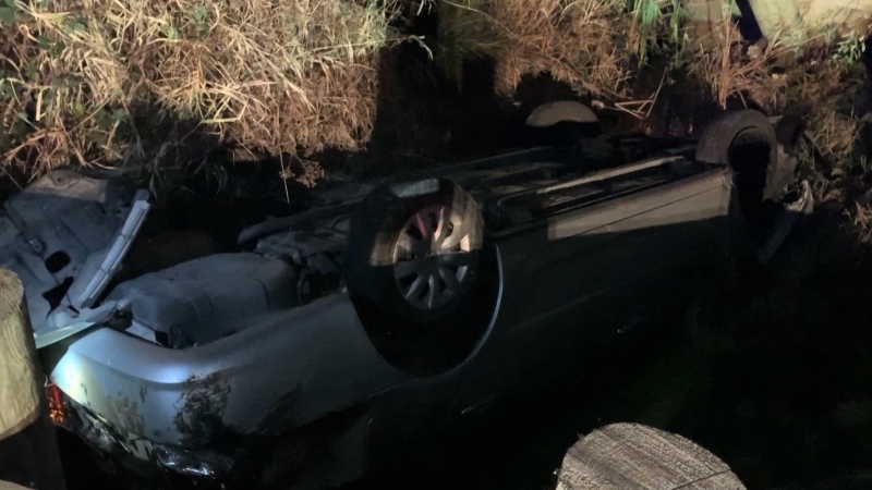 A car was seen upside down in a ditch in Surrey. 