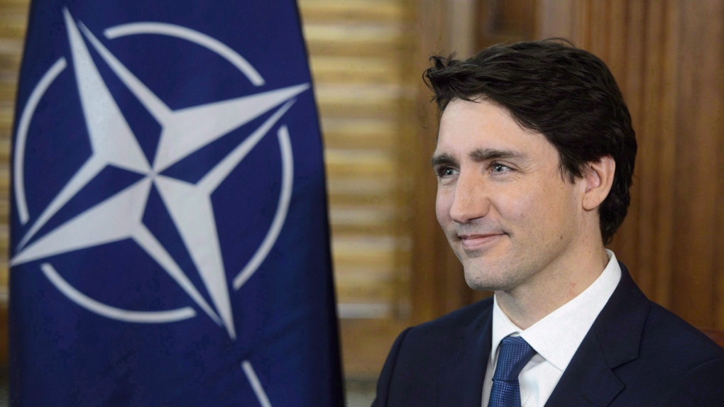 Prime Minister Justin Trudeau with the NATO flag