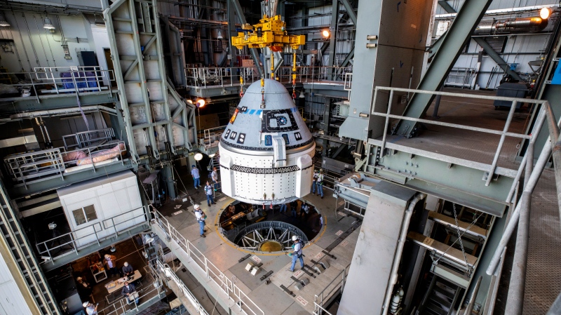 In this Nov. 21, 2019 photo provided by NASA, the Boeing CST-100 Starliner spacecraft is guided into position above a United Launch Alliance Atlas V rocket at the Vertical Integration Facility at Space Launch Complex 41 at Florida’s Cape Canaveral Air Force Station. (Cory Huston/NASA via AP)