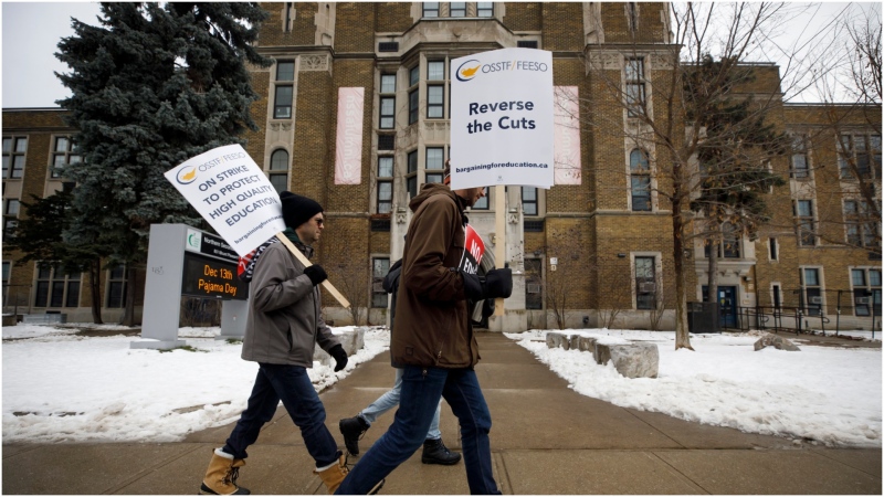 Striking teachers of the Ontario Secondary School Teachers Federation walk the picket line outside of Northern Secondary School in Toronto, Wednesday, Dec. 4, 2019. THE CANADIAN PRESS/Cole Burston