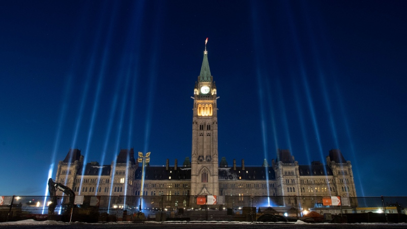 Fourteen lights illuminate the sky over the Parliament buildings on the 30th anniversary of the 1989 Ecole Polytechnique Montreal tragedy Friday December 6, 2019 in Ottawa. THE CANADIAN PRESS/Adrian Wyld