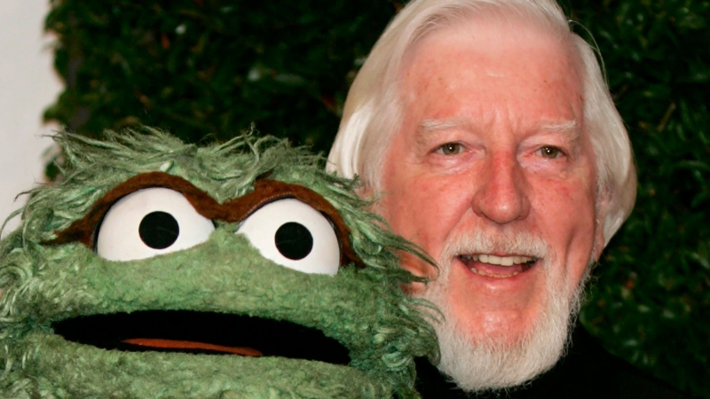 In this Thursday, April 27, 2006, file photo, Caroll Spinney, right, who portrays "Sesame Street" characters Oscar The Grouch, left, and Big Bird, arrives for the Daytime Emmy nominee party at the Hollywood Roosevelt Hotel in Los Angeles. Spinney, who gave Big Bird his warmth and Oscar the Grouch his growl for nearly 50 years on "Sesame Street," died Sunday, Dec. 8, 2019, at the age of 85 at his home in Connecticut, according to the Sesame Workshop. (AP Photo/Reed Saxon, File)
