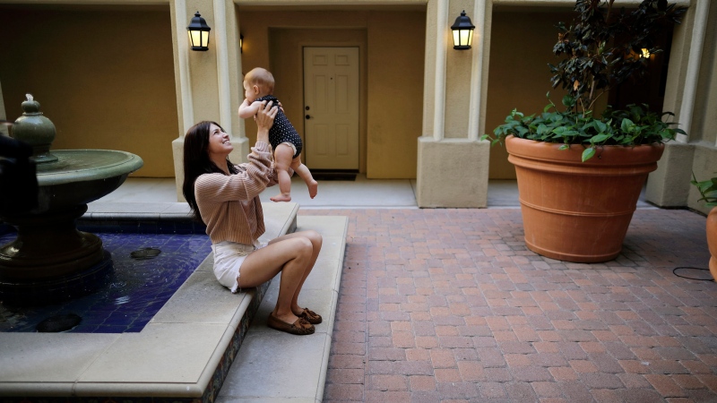 In this Aug. 24, 2018 file photo Keira Sumimoto plays with her daughter, in Irvine, Calif. Sumimoto, who used marijuana briefly for medical reasons while pregnant and breastfeeding, says her daughter is healthy and advanced for her age. (AP Photo/Gregory Bull)