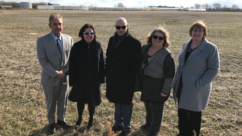 Officials stand at the site of the new school in Kingsville, Ont., on Wednesday, Dec. 18, 2019. (MNIchelle Maluske / CTV Windsor)