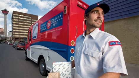 A Canada Post employee is seen in this undated image made available to media by Canada Post.