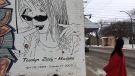 Bev Zizzy, left, admires a mural of her late daughter that may be torn down. (Taylor Rattray / CTV News Regina)
