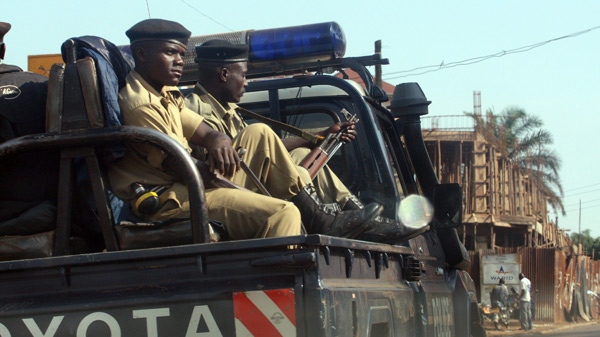 Ugandan armed police sit on a van as they patrol a street in Kampala, Uganda, Saturday, Sept. 12, 2009, following two nights of clashes between ethnic Buganda people and Uganda security forces. (AP / Sayyid Azim) 