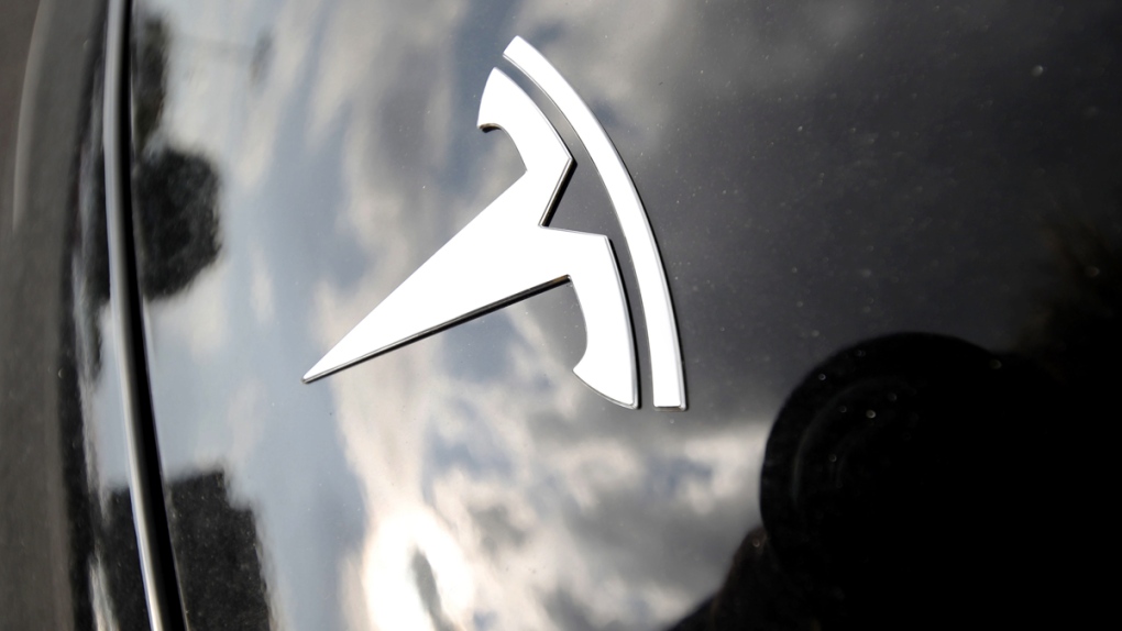 The company logo on the hood of a Tesla vehicle