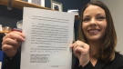 Ashley Harmon, a partner with the Windsor law firm Legal Focus, holds up a legal document in Windsor on Monday, Jan. 6, 2020. (Ricardo Veneza / CTV Windsor)