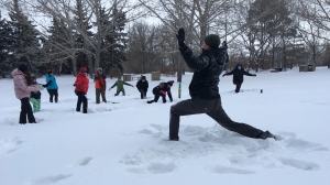 Regina residents tried out a snowy yoga-alternative called "snoga," in the cold over the weekend. (Cole Davenport/CTV News)