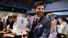 Tareq Hadhad holds his citizenship paper at the Oath of Citizenship ceremony at The Canadian Museum of Immigration at Pier 21 in Halifax on Wednesday, Jan. 15, 2020. (THE CANADIAN PRESS/Riley Smith)