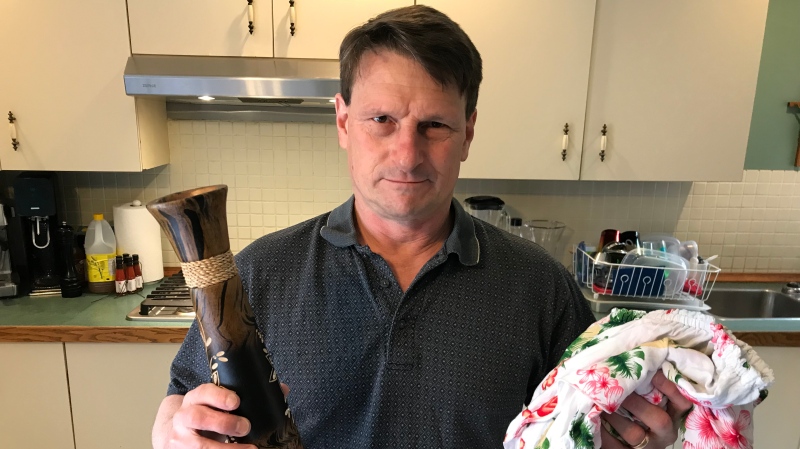 Rejent Guay holds up a vase and some clothing he purchased for his daughter while he was on vacation. (Pat Foran/CTV News Toronto)