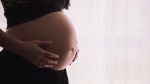 A pregnant person is seen in this file photo. (Pexels/freestocks.org)