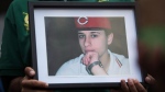 A photo of Sammy Yatim is held by one of the teen's friends at a Toronto courthouse after the sentencing of Const. James Forcillo in Toronto on Thursday, July 28, 2016. THE CANADIAN PRESS/Michelle Siu