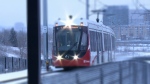 A westbound train travels along the Confederation Line of Ottawa's Light Rail System.