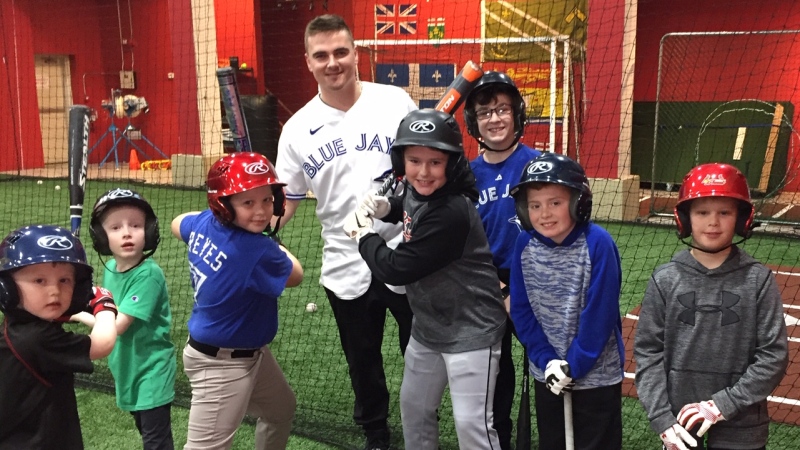 Toronto Blue Jays' catcher Reese McGuire poses with kids at a hitting clinic in St. Thomas, Ont. on Wednesday, Jan. 22, 2020. (Reta Ismail / CTV London)