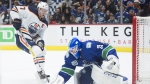 Edmonton Oilers centre Connor McDavid (97) fails to get a shot past Vancouver Canucks goaltender Jacob Markstrom (25) during third period NHL action in Vancouver on Monday, December, 23, 2019. When the NHL returns from its bye weeks and all-star break, there will be just over 30 games left for each team. THE CANADIAN PRESS/Jonathan Hayward