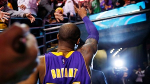 Los Angeles Lakers' Kobe Bryant acknowledges the fans as he walks of the court in Boston after the Lakers' 112-104 win over the Boston Celtics in an NBA basketball game Wednesday, Dec. 30, 2015. (AP Photo/Winslow Townson)