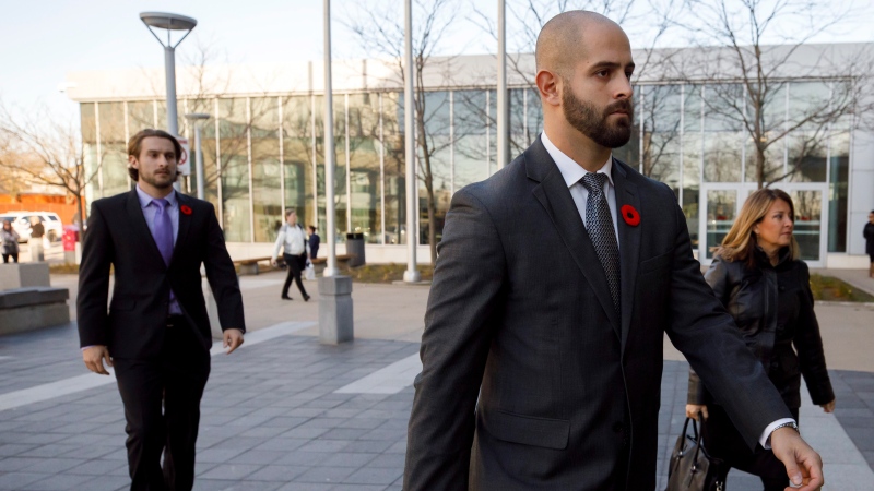 Michael Theriault, centre, and Christian Theriault, left, arrive at the Durham Region Courthouse in Oshawa, Ont., ahead of Dafonte MIller's testimony, on Wednesday, Nov. 6, 2019. THE CANADIAN PRESS/Cole Burston