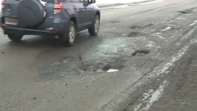 pothole-littered road
