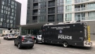 Toronto police vehicles are seen outside of a downtown condo building after a deadly shooting took place inside a unit being rented out as an Airbnb. (CTV News Toronto) 