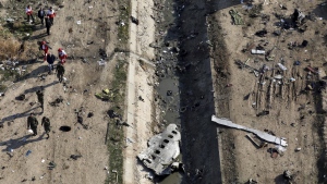 Rescue workers search the scene where a Ukrainian plane crashed in Shahedshahr, southwest of the capital Tehran, Iran on Wednesday, Jan. 8, 2020. THE CANADIAN PRESS/AP-Ebrahim Noroozi