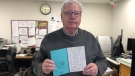 Barry Rutherford holds a thank-you card from one of the schools to which the group has donated. (Carla Shynkaruk/CTV Saskatoon) 