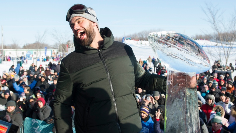 Super Bowl champion and Kansas City Chiefs player Laurent Duvernay-Tardif reacts next to an ice sculpture of the Vince Lombardi trophy during an event to celebrate his win in Montreal, Sunday, February 9, 2020. THE CANADIAN PRESS/Graham Hughes