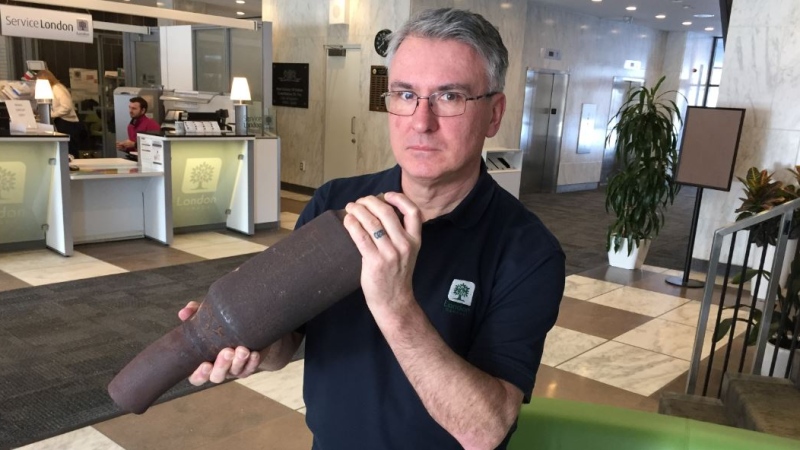 London, Ont. bylaw enforcement manager Orest Katolyk holds up a catalytic converter sawed off of a vehicle's exhaust system, Monday, Feb. 10, 2020. (Bryan Bicknell/CTV London)