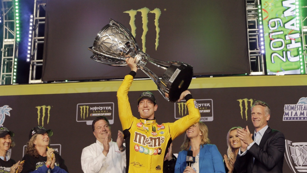 Kyle Busch, centre, holds up his trophy