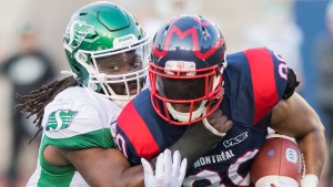 Montreal Alouettes' Spencer Moore, right, is tackled by Saskatchewan Roughriders' Solomon Elimimian during first half CFL football action in Montreal, Friday, August 9, 2019. THE CANADIAN PRESS/Graham Hughes