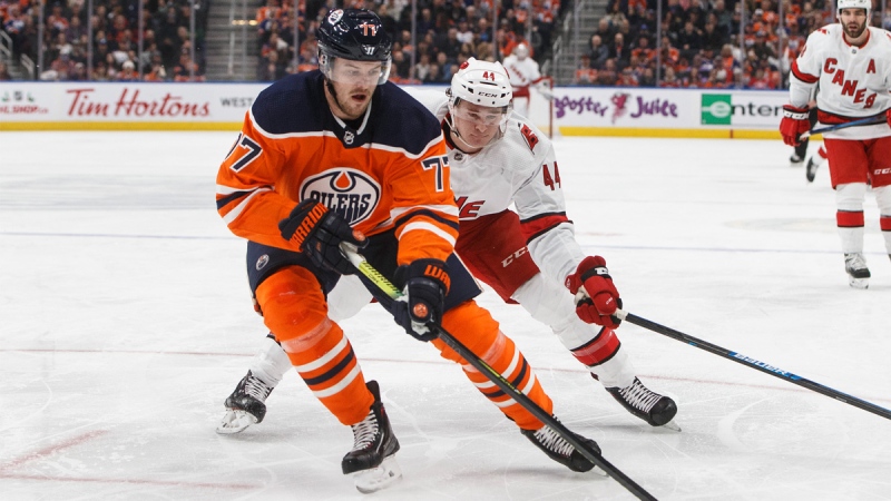 Carolina Hurricanes' Julien Gauthier chases Edmonton Oilers' Oscar Klefbom (77) during first period NHL action in Edmonton, Alta., on Tuesday December 10, 2019. THE CANADIAN PRESS/Jason Franson