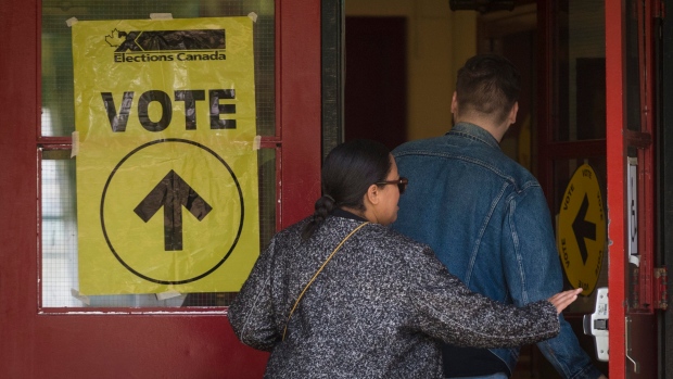 Voters enter the polling station at St. Rita Catholic School during election day in Toronto on Monday, October 21, 2019. THE CANADIAN PRESS/ Tijana Martin