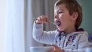 A kid is eating breakfast in this stock image. (Source:istockphoto.com)
