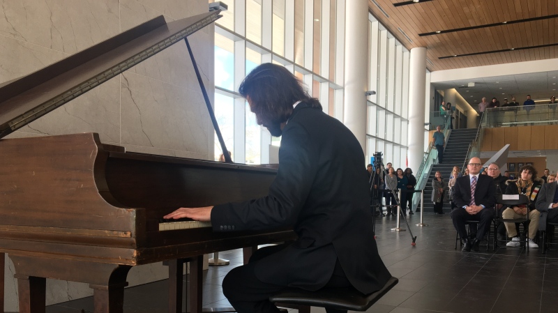A piano bought by the grandsons of Hiram Walker is played for the first time at its new home at Windsor city hall by Samuel Blase Fedele, a Unviersity of Windsor student, on Feb. 28, 2020. (Ricardo Veneza/CTV Windsor)