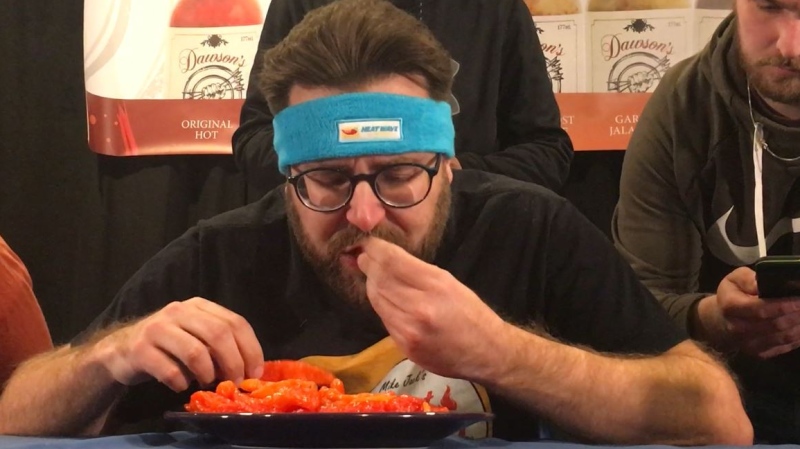 Mike Jack breaking the world record for ghost pepper eating in London Ont. on Feb. 29, 2020. (Brent Lale/CTV)