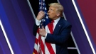 U.S. President Donald Trump kisses the American flag after speaking at Conservative Political Action Conference, CPAC 2020, at the National Harbor in Oxon Hill, Md., Saturday, Feb. 29, 2020. (AP Photo/Jose Luis Magana)