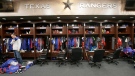 In this Oct. 11, 2016, file photo, Texas Rangers pitcher Sam Dyson, left, packs a bag in the locker room at the baseball park in Arlington, Texas. The NBA, NHL, Major League Baseball and Major League Soccer are closing access to locker rooms and clubhouses to all non-essential personnel in response to the coronavirus crisis, the leagues announced in a joint statement Monday, March 9, 2020. (AP Photo/LM Otero, File)
