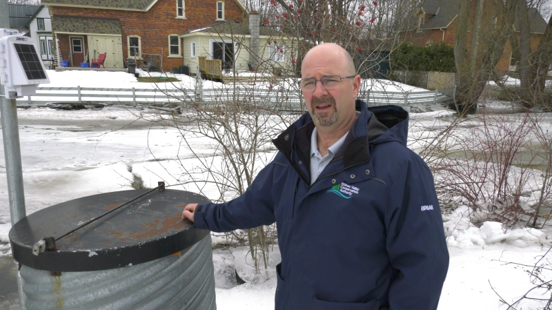 Brian Stratton of the Rideau Valley Conservation Authority stands beside the Davis Weather Station (Nathan Vandermeer/CTV News Ottawa)
