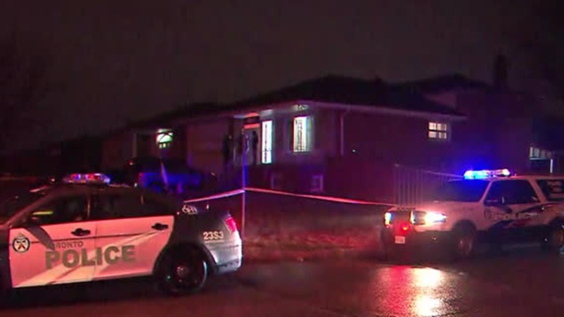 Police are seen outside an Etobicoke home after a woman was shot in the arm on March 13, 2020. (CP24)