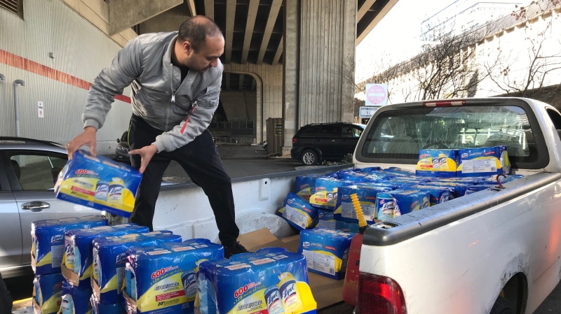 Manny Ranga loads his truck with Lysol wipes that he bought in bulk Wednesday at a Costco store near downtown Vancouver. Ranga and his wife buy the supplies in bulk ad resell them on Amazon. (Douglas Quan/Toronto Star)