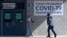 A man makes his way to a COVID-19 assessment centre setup at a city building Saturday, March 14, 2020 in Ottawa. (Adrian Wyld/THE CANADIAN PRESS)