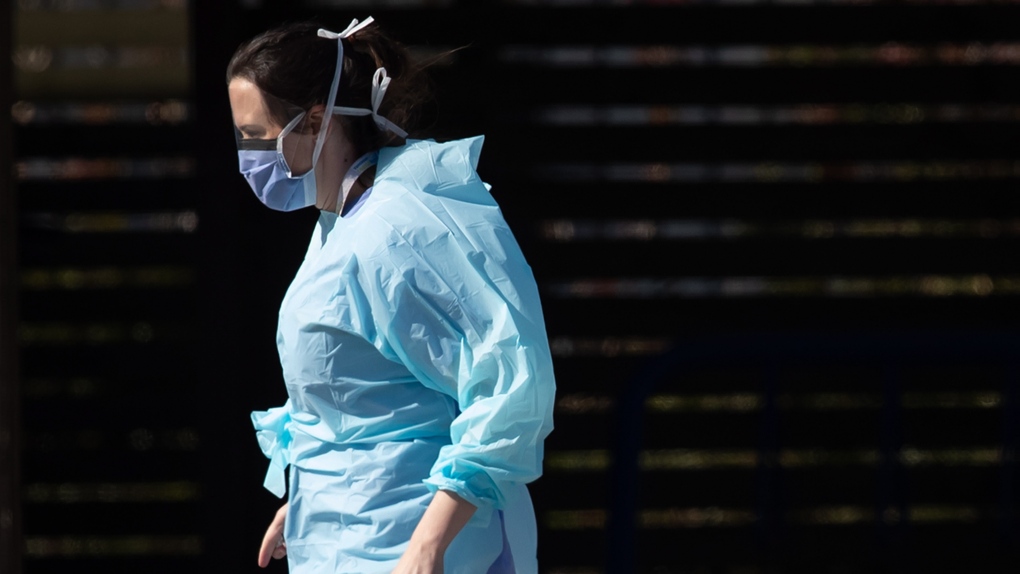 A hospital worker wearing a face shield and mask i